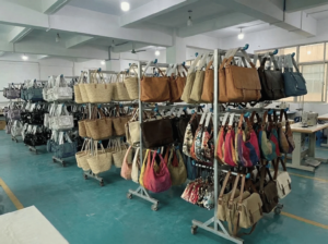 A spacious room filled with various bags displayed on shelves and tables, showcasing a wide selection of styles and colors.