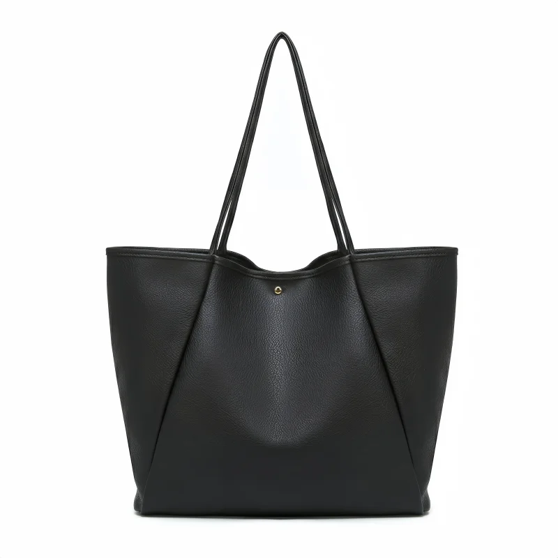 A black leather tote bag displayed against a neutral background, showcasing its sleek design and sturdy handles.